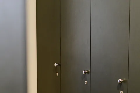 Dark lockers in a gym changing room.