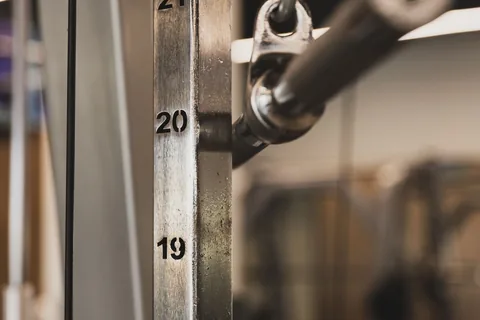 Close view of numbered plates in a gym weight stack.