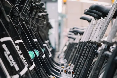 A row of stationary exercise bicycles.