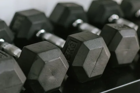 Hex dumbbells stored on a gym rack.